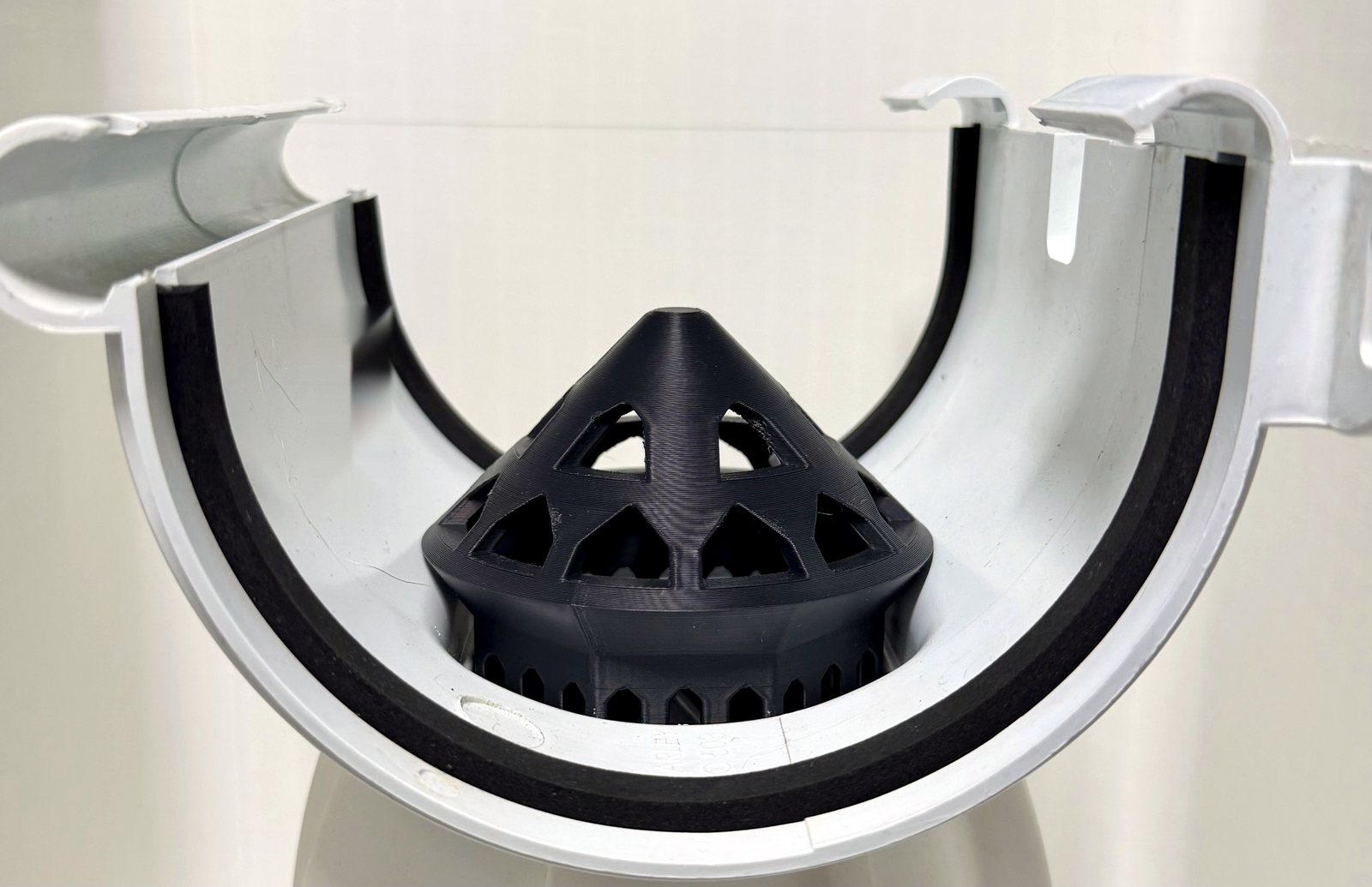 GG-MA leaf guard fitted in the outlet of a Marley Vynadeep half-round gutter